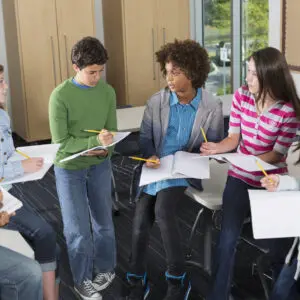 Diverse students studying together in a casual indoor setting.