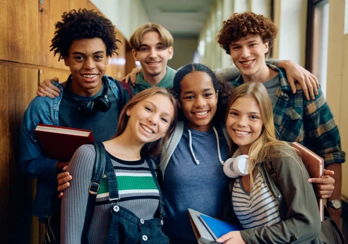 Group of smiling students in hallway